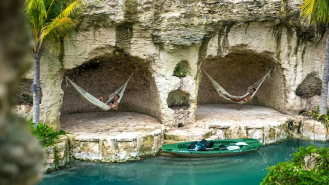 Hammocks at cenote pool at Hotel Xcaret Playa del Carmen resort